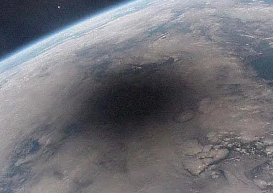 During a solar eclipse, the moon casting a large shadow onto Earth's surface.