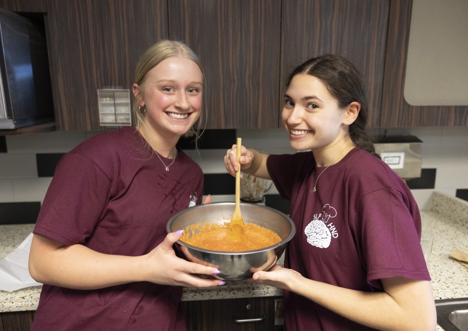Two female student cooking