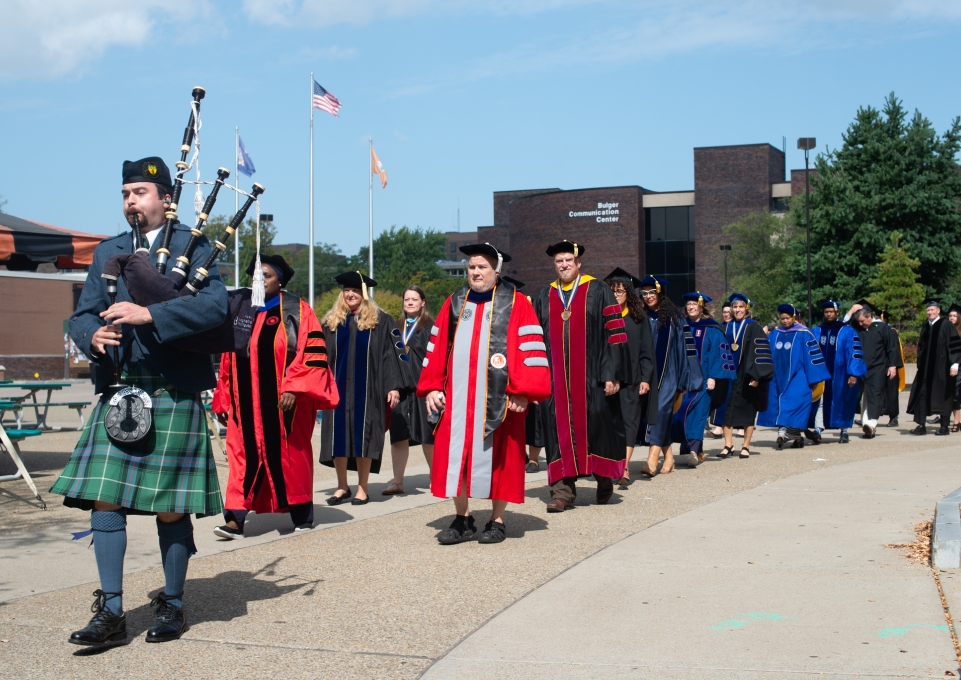 Academic convocation marchers and bagpiper