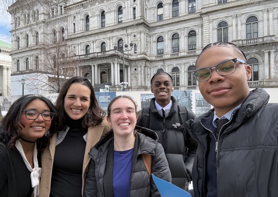 Five college students in front of a building